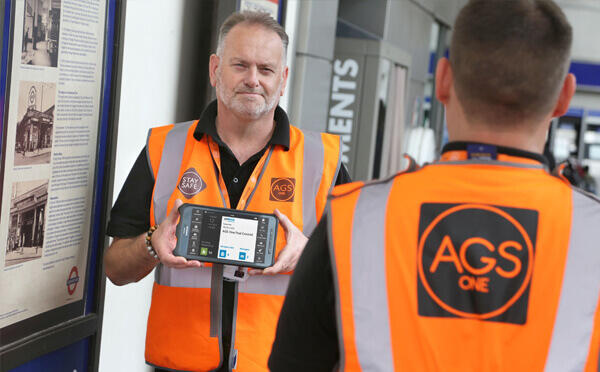 BigChange AGS man holding tablet