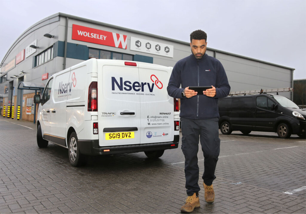 Nserv employee using a BigChange mobile device to increase is organise his workflow