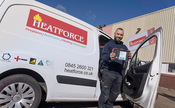 Heatforce employee holding a mobile BigChange device