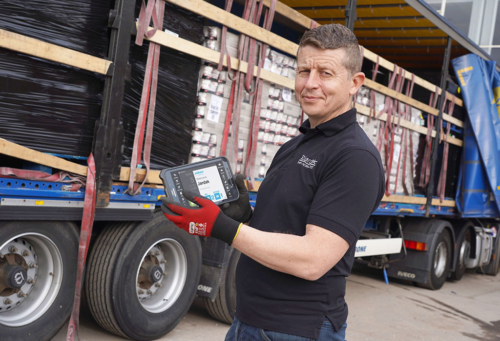 Jardak employee holding a JobWatch mobile device