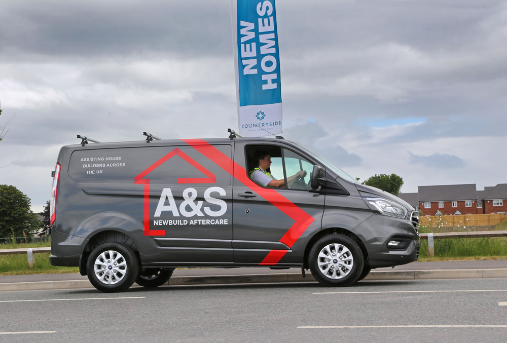 A&S Newbuild Aftercare employee driving a branded van