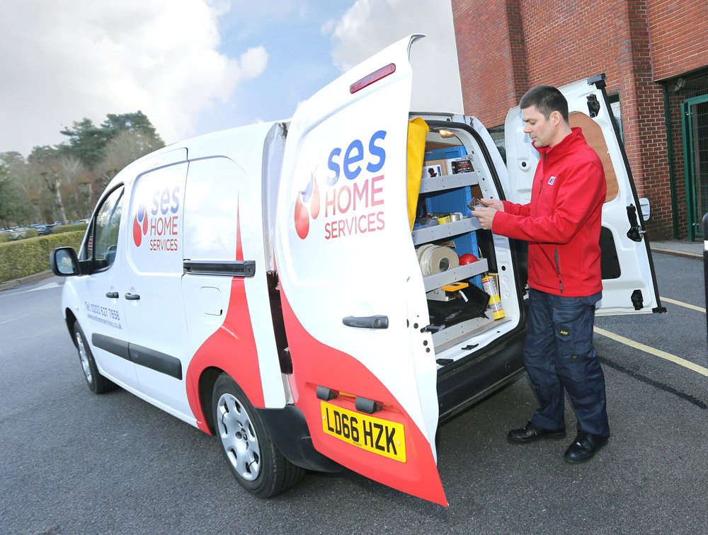 SES employee holding a BigChange mobile device