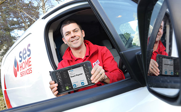 SES emplooyee holding a BigCHange JobWatch mobile device