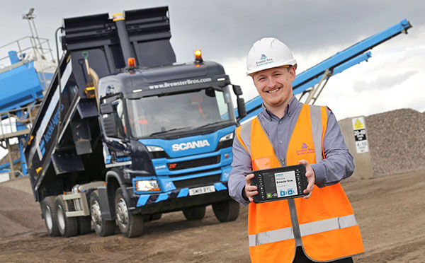 Brewster Bros. employee holding a jobwatch mobile device