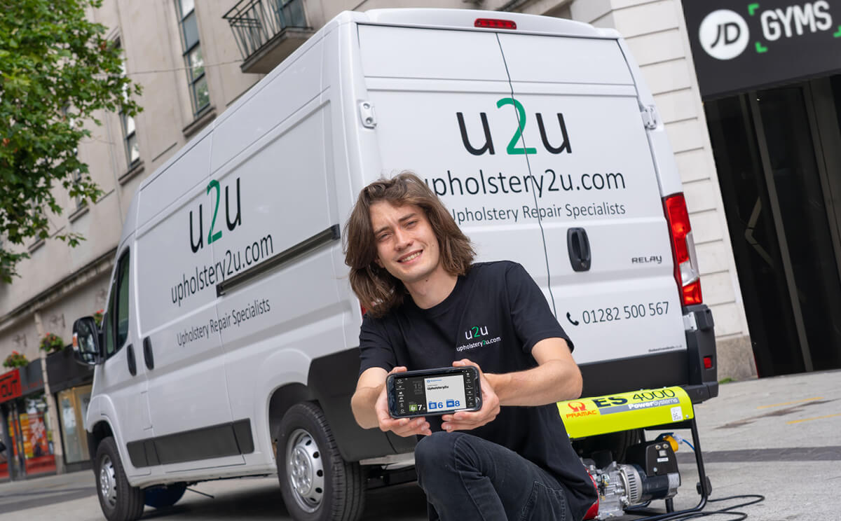 Upholstery2U engineer in front of van holding BigChange tablet